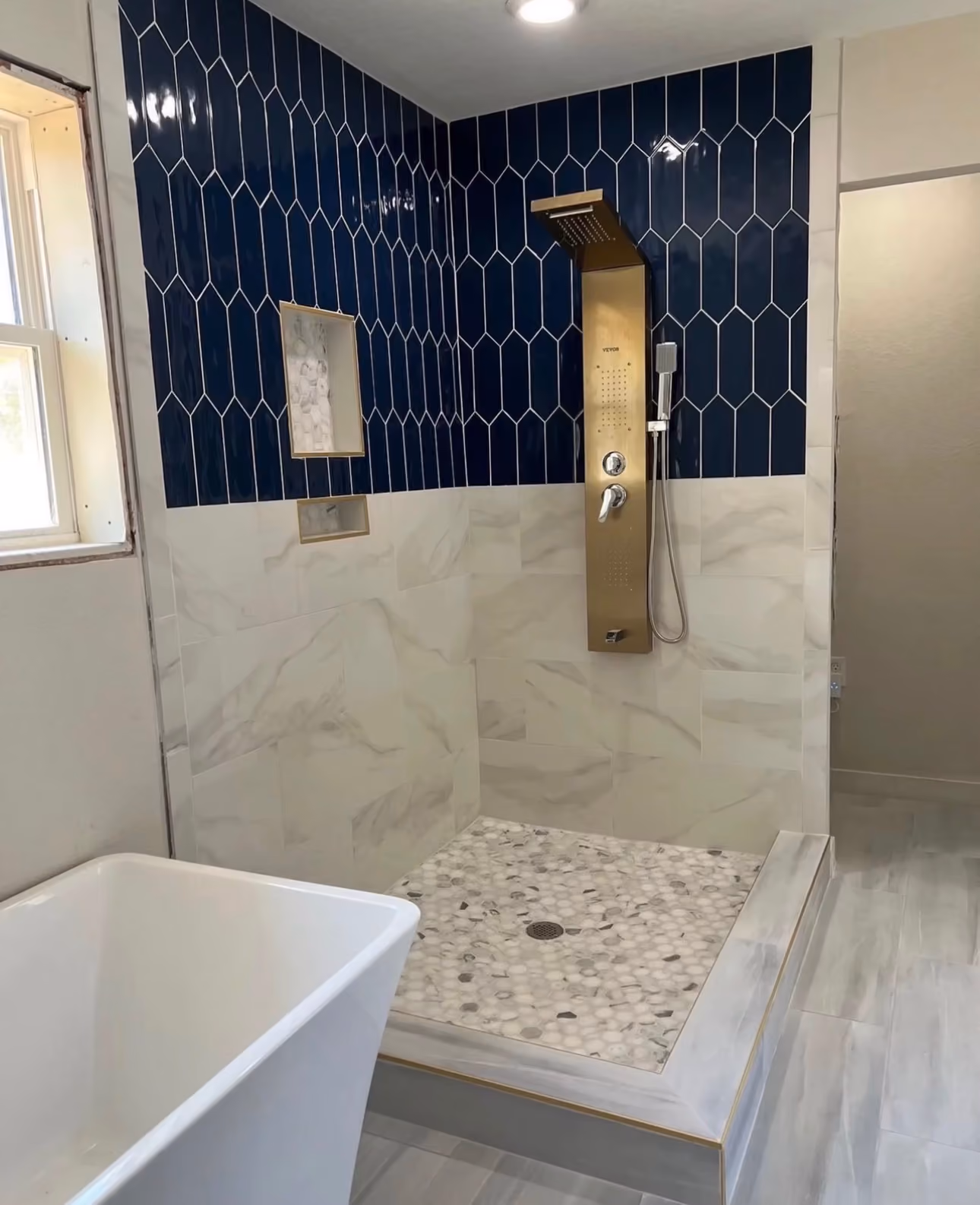 Custom walk-in shower featuring premium tile work and designer finishes