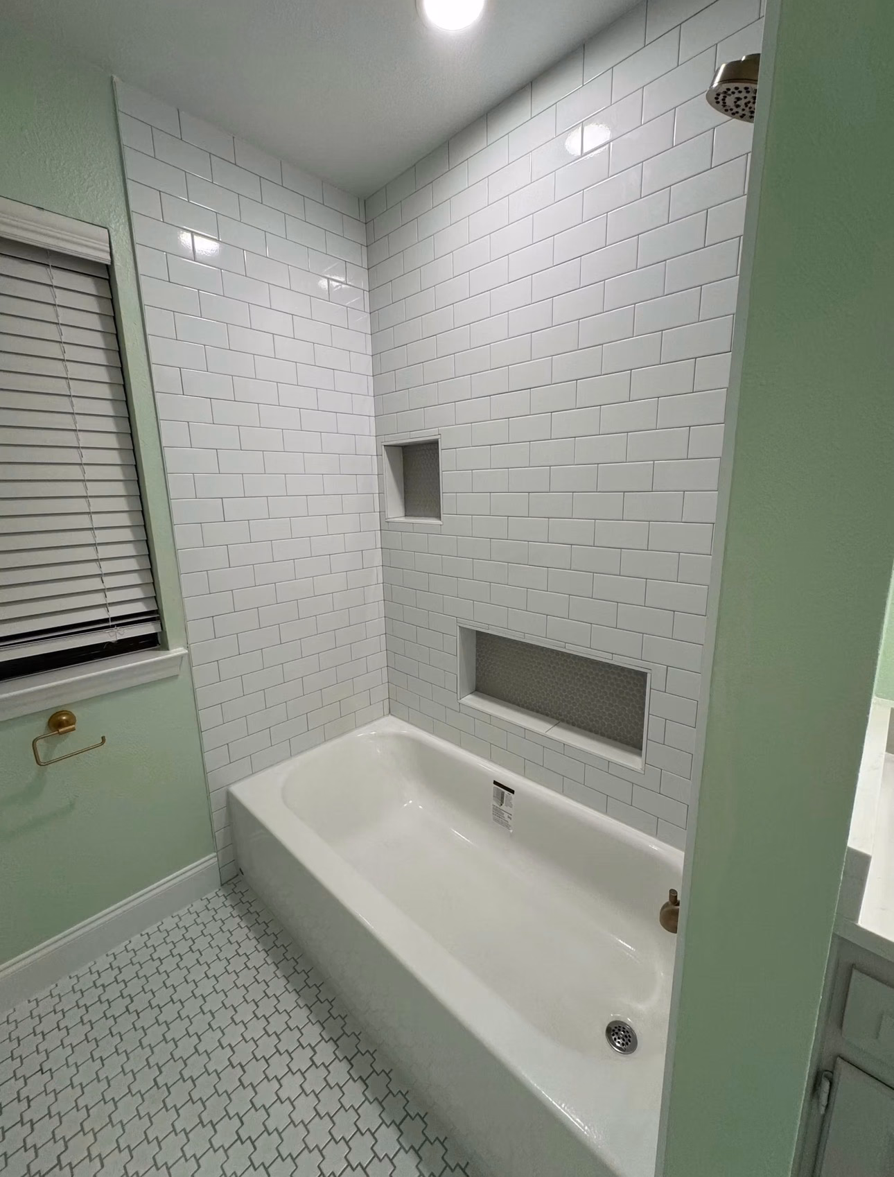 Modern bathroom renovation with custom tile work, fresh paint, and a redesigned layout for a more spacious feel