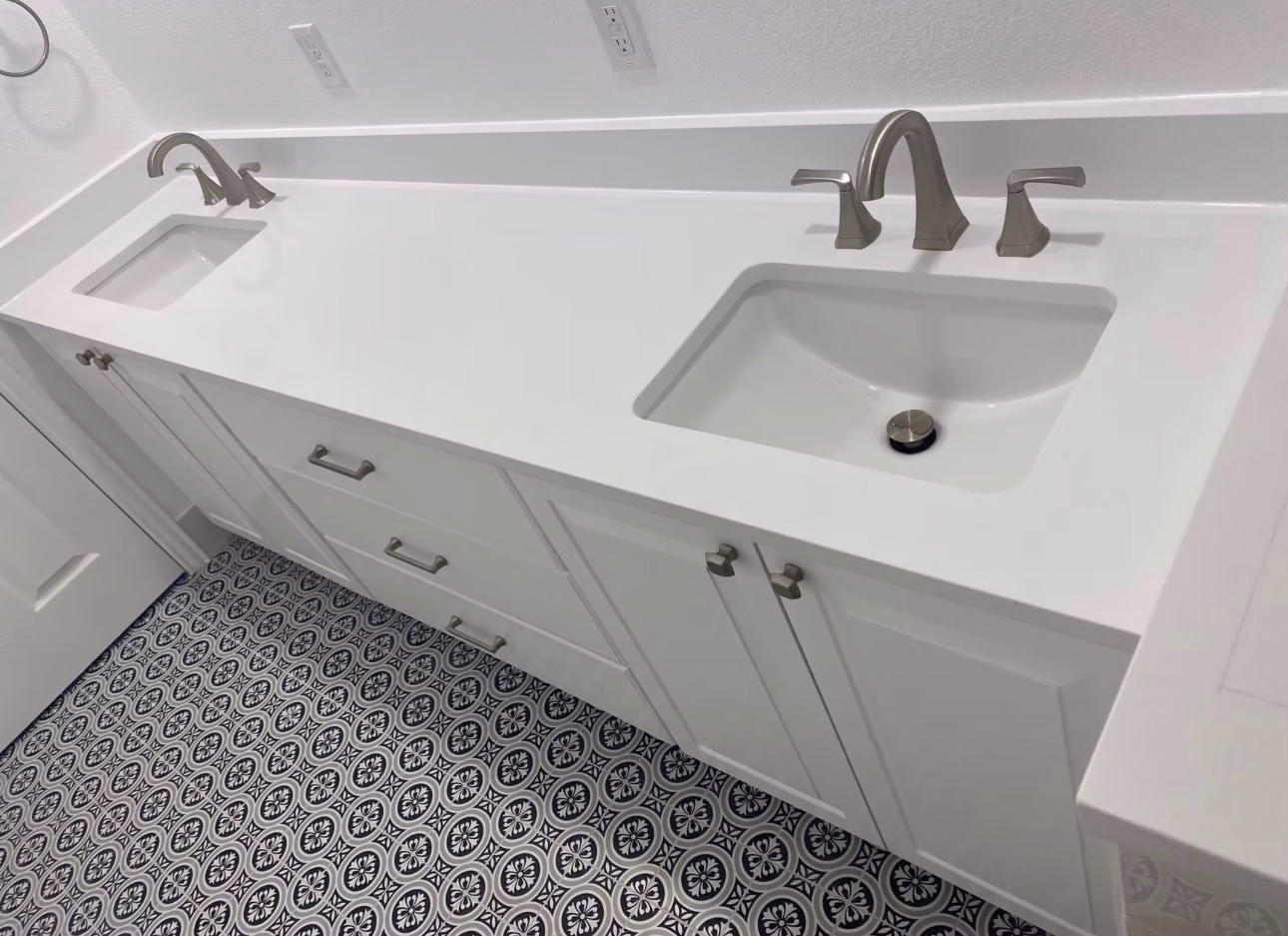 Bathroom renovation with fresh paint, new floor tile, and a new vanity